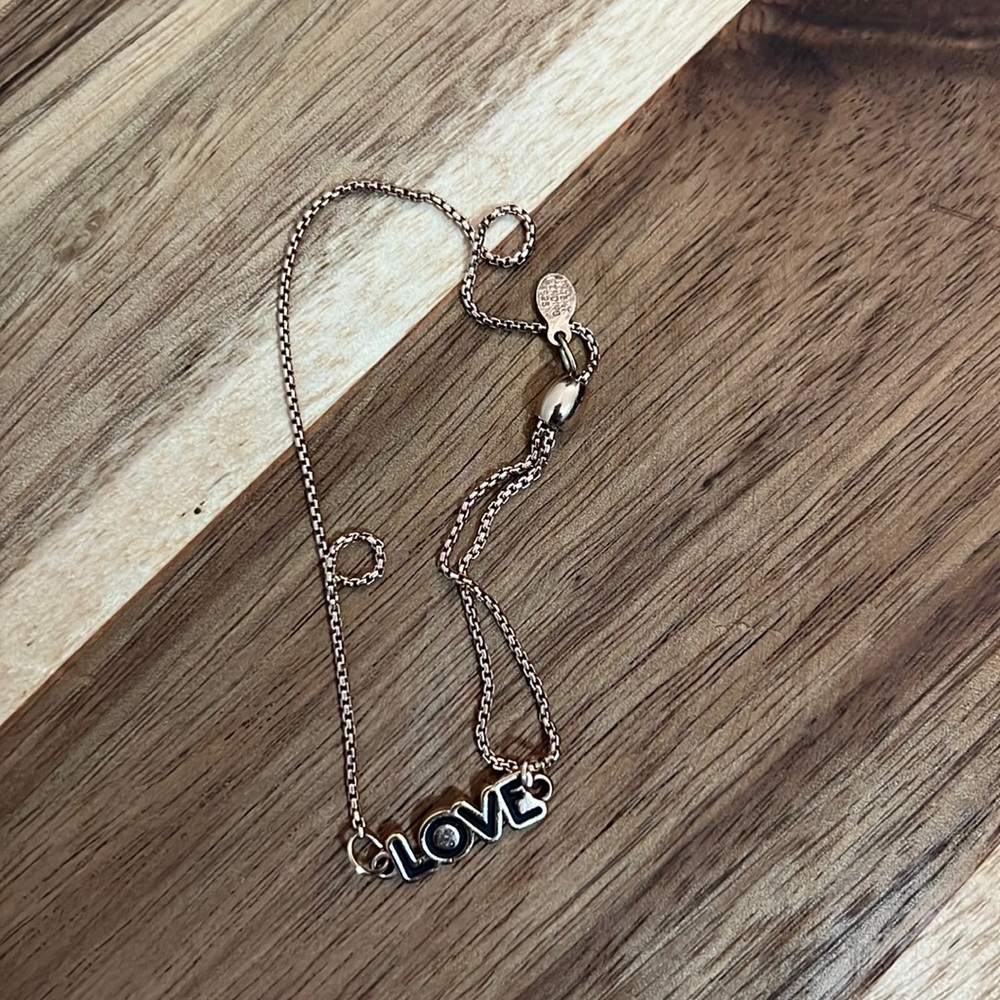 Alex and Ani rose gold “LOVE” bracelet.